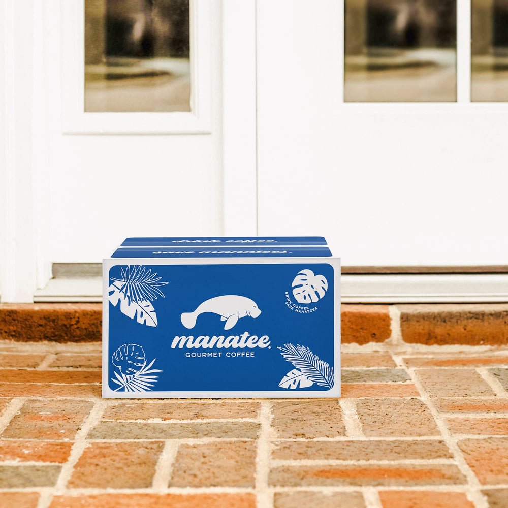 Hand holding Manatee Gourmet 2 lb bag to show scale and convenience for frequent brewers