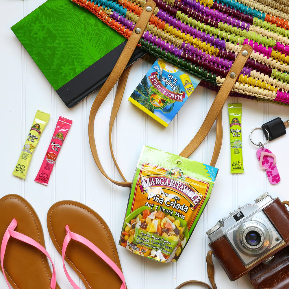Margaritaville packet next to hand to show compact size and travel ease