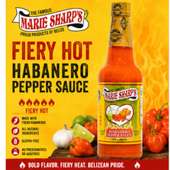 Marie Sharp's sauce being poured onto tacos adding bold flavor and intense spice