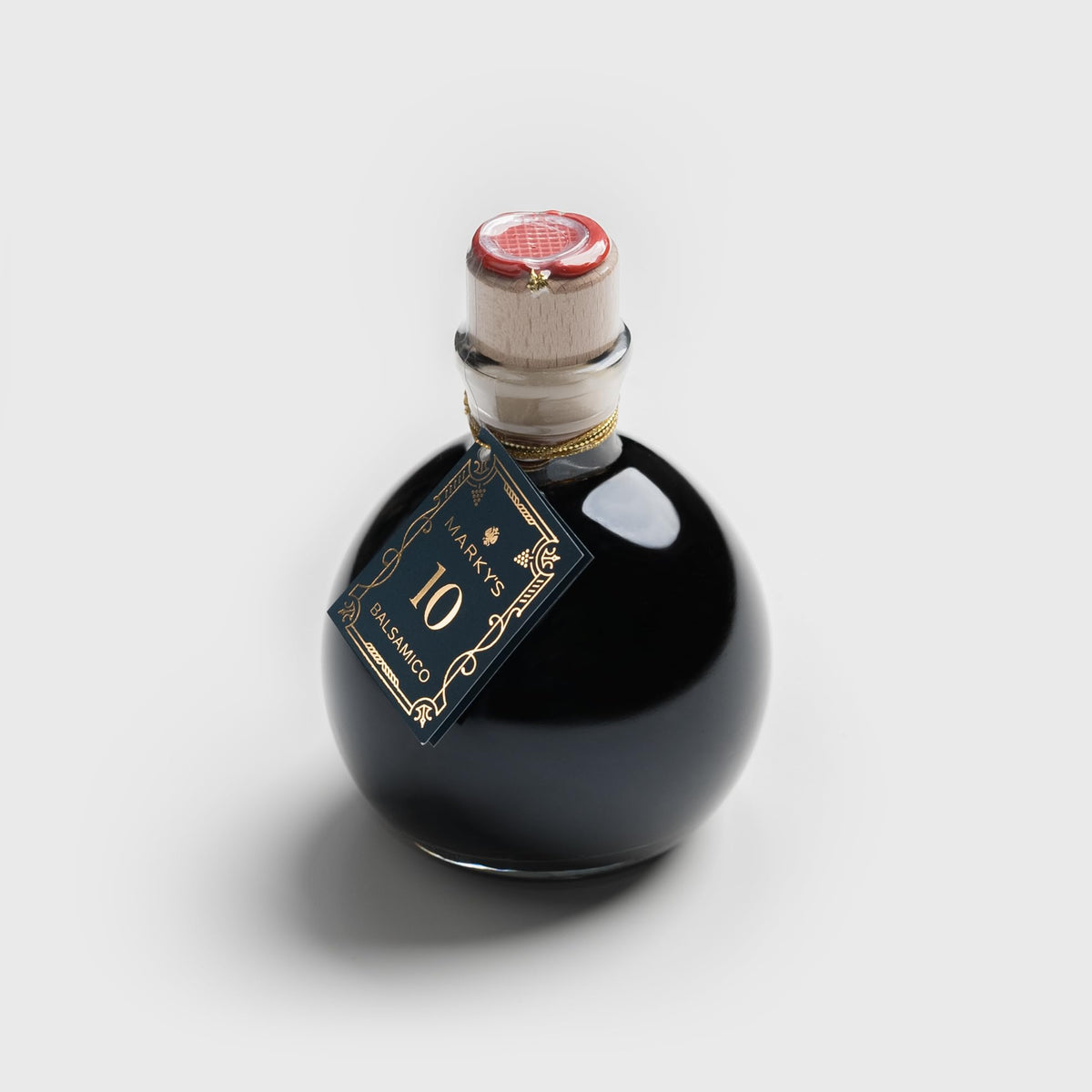 MARKY'S bottle front view showing dark aged balsamic and branding benefit