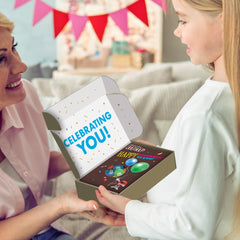 M&M'S candies spread on surface beside box showing size and colorful shells