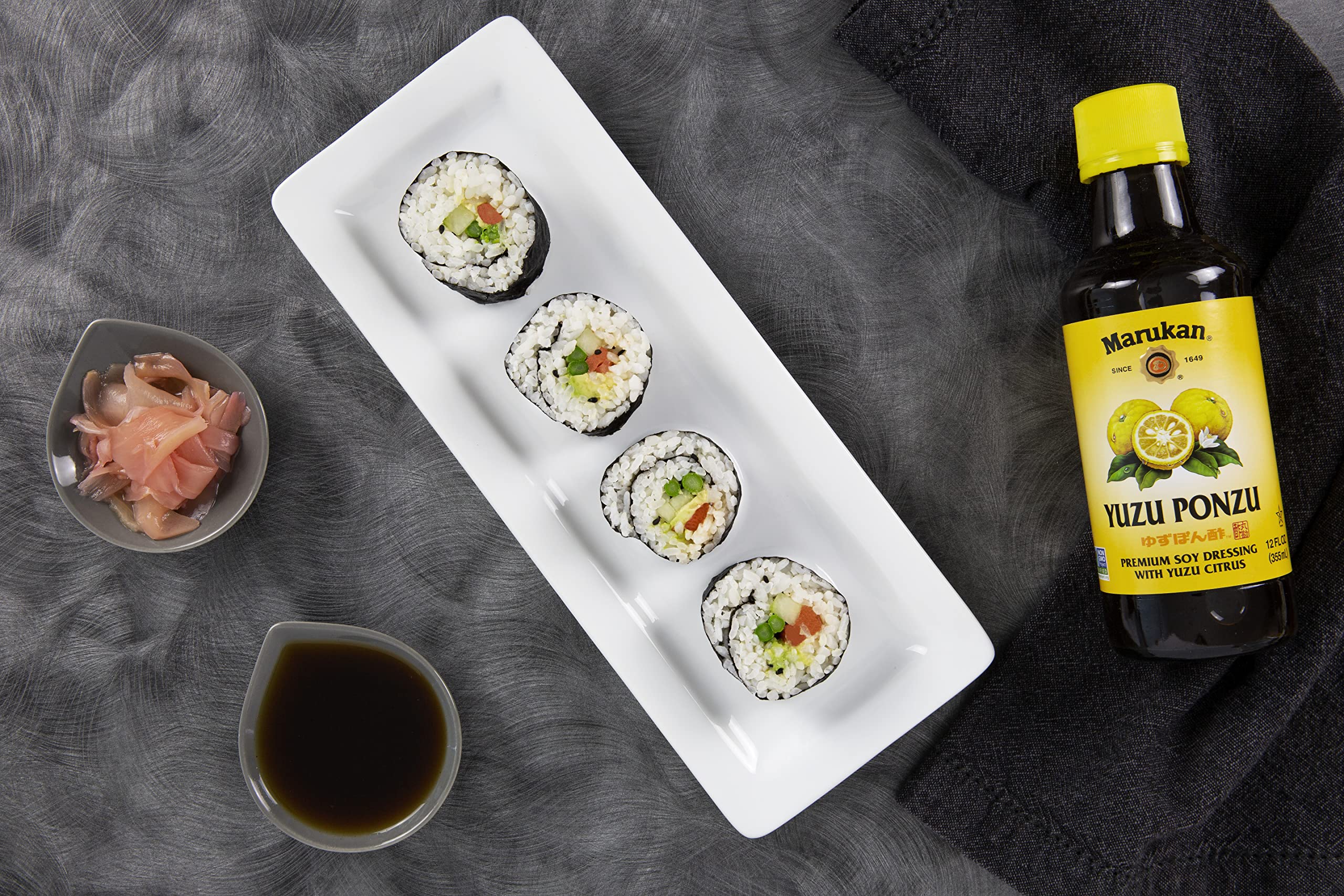 Marukan ponzu yuzu drizzled on salad demonstrating fresh citrus lift and versatile use