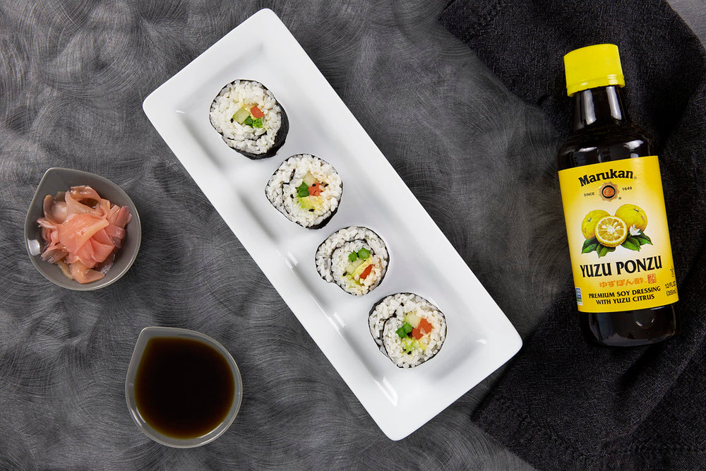 Marukan ponzu yuzu drizzled on salad demonstrating fresh citrus lift and versatile use