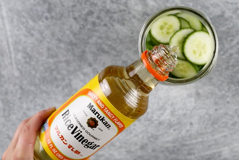 Marukan vinegar beside salad bowl showing lighter dressing flavor benefit