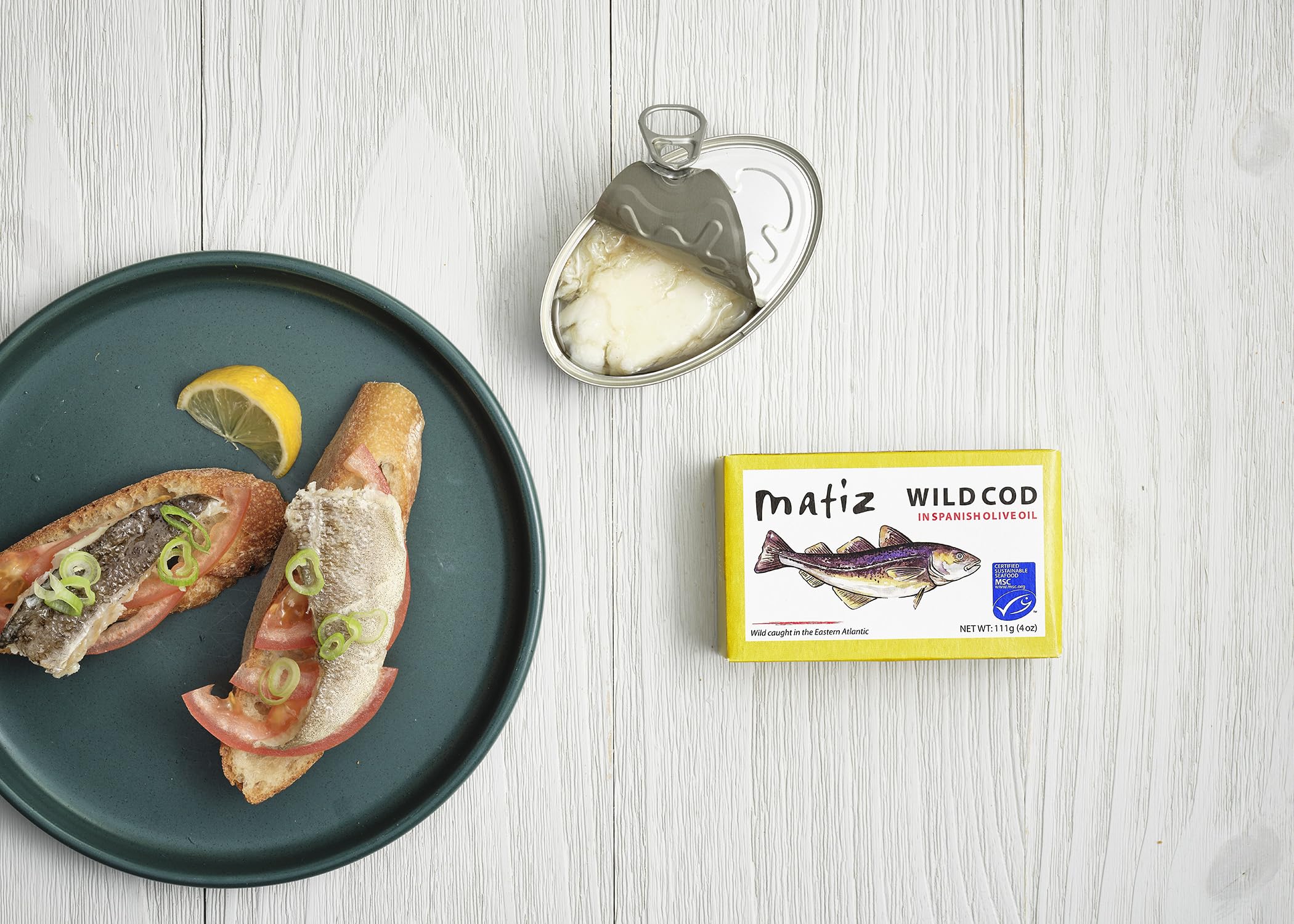 Matiz close-up of olive oil texture bathing cod, highlighting moist preservation