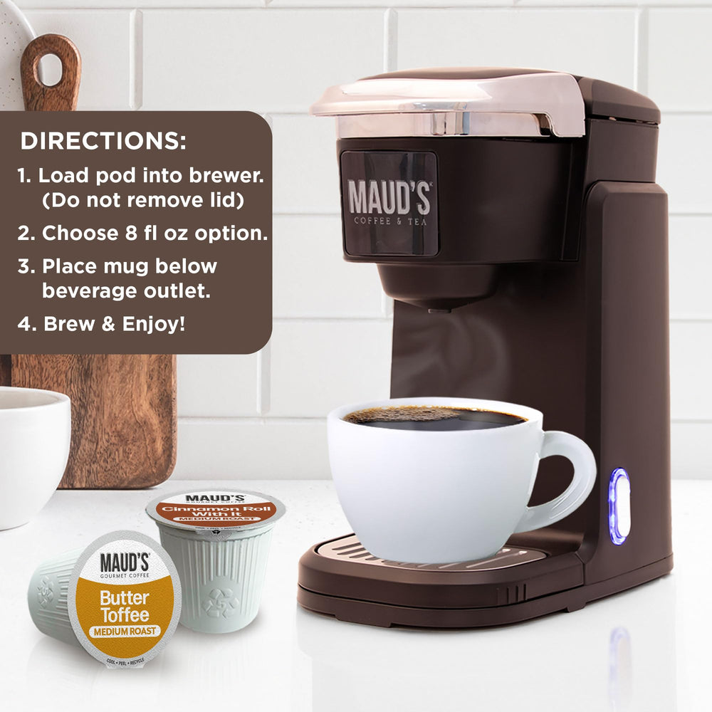 Maud's pod held in hand for scale, demonstrating compact single-serve convenience
