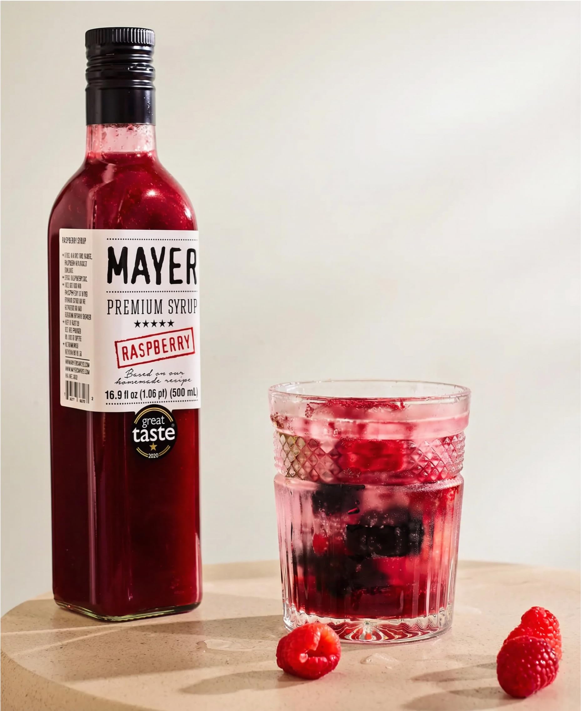 Fresh raspberries and Mayer bottle illustrating real fruit ingredient advantage