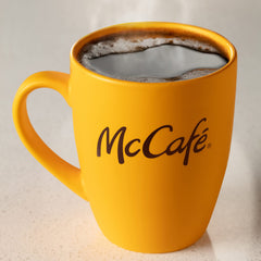 McCafé scoop measuring grounds with brewing setup for consistent cups