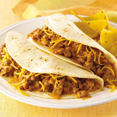 Prepared tacos filled with seasoned meat showing McCormick mix creates family-friendly meal