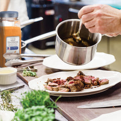 McCormick Culinary being applied to steak before cooking showing tenderizing benefit