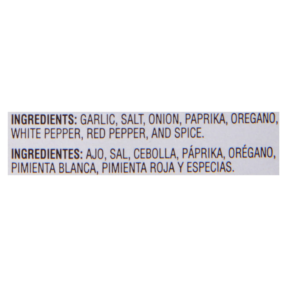 Chef in a commercial kitchen using McCormick Culinary Cajun to season a large tray