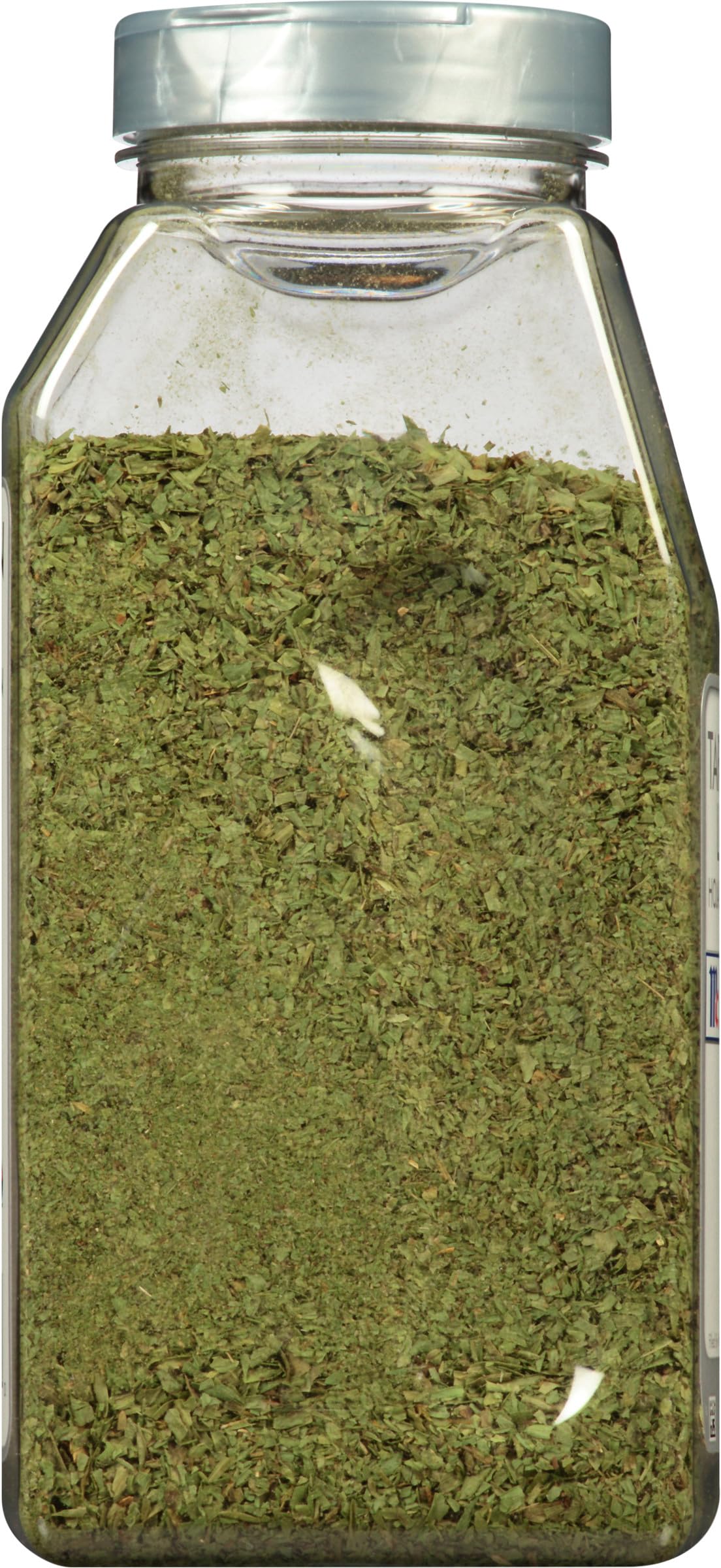 McCormick Culinary jar opened and spooning leaves to measure for recipes