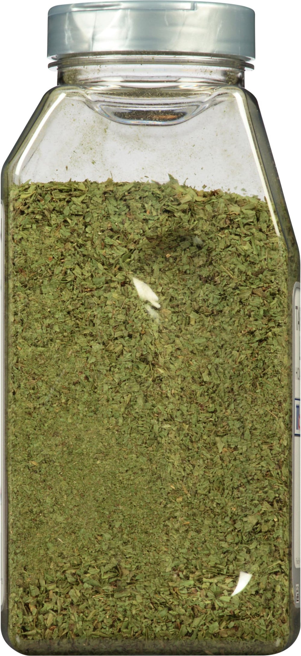 McCormick Culinary jar opened and spooning leaves to measure for recipes