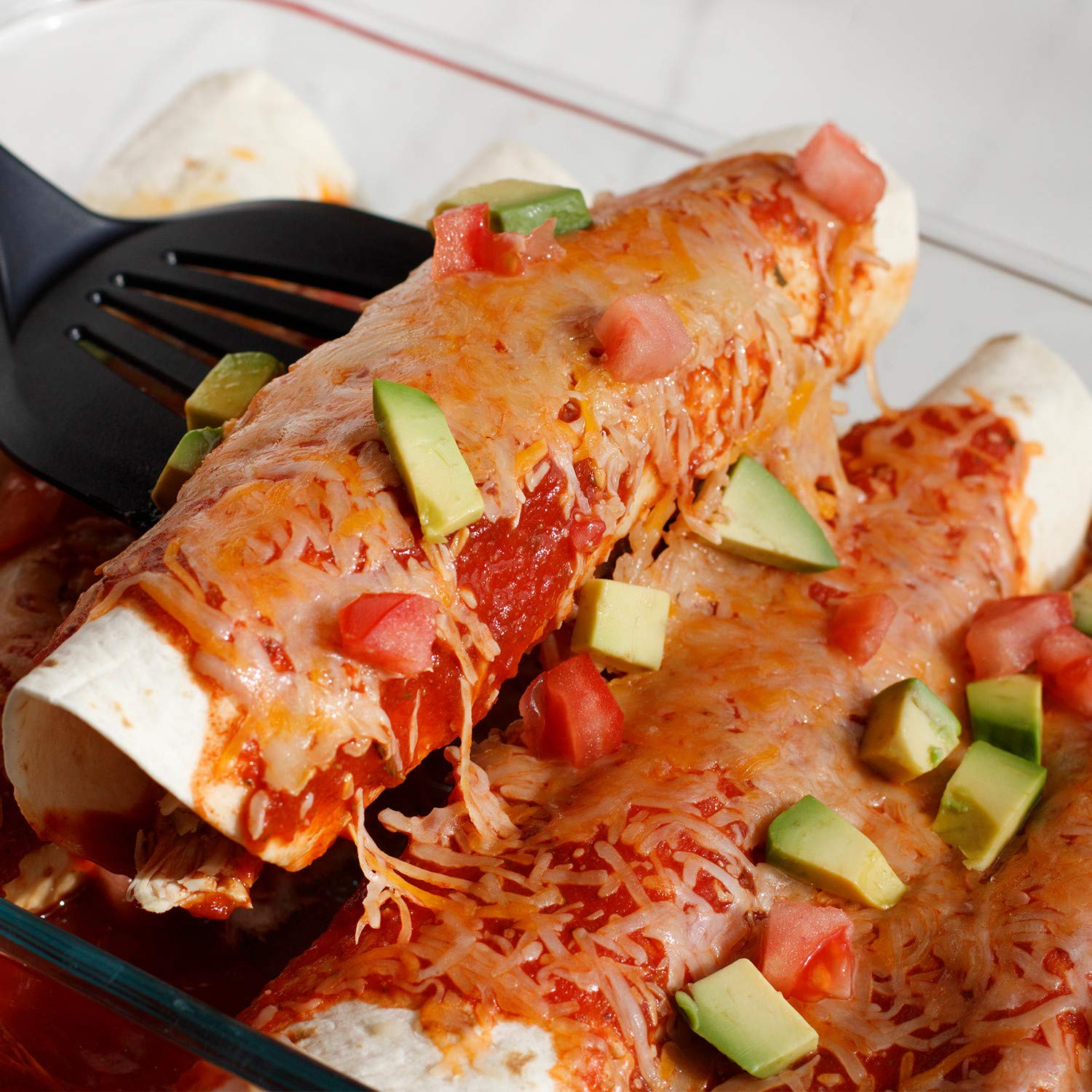 Serving of enchiladas on a plate prepared with McCormick sauce mix, showcases crowd-pleasing taste