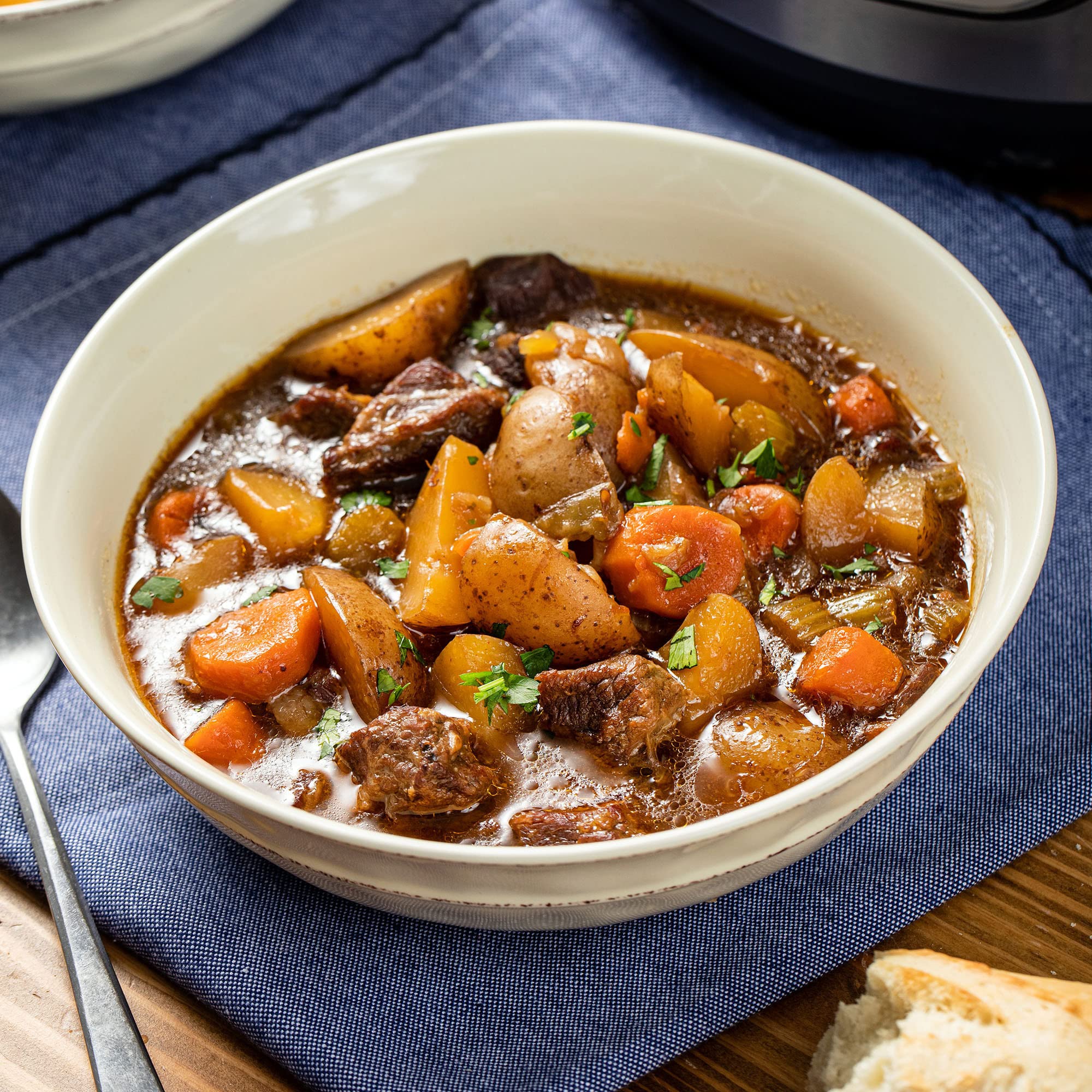 McCormick seasoning mixed into a slow cooker beef stew showing rich color and hearty result