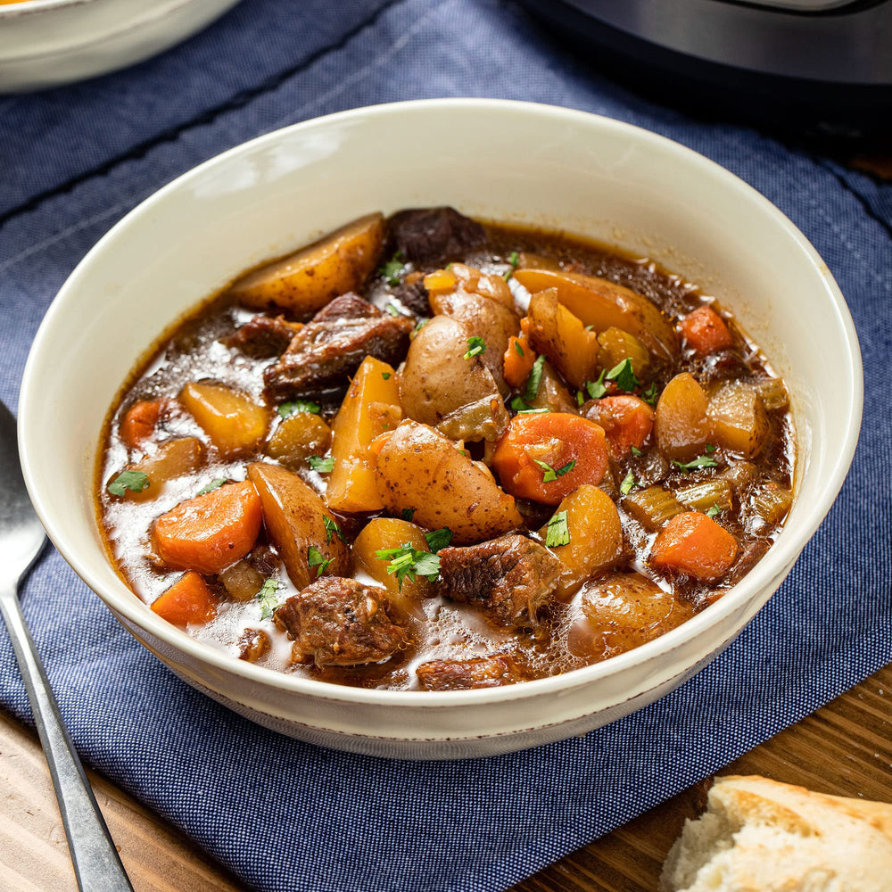 McCormick seasoning mixed into a slow cooker beef stew showing rich color and hearty result