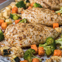 McCormick ONE being sprinkled on raw chicken to add flavor before roasting