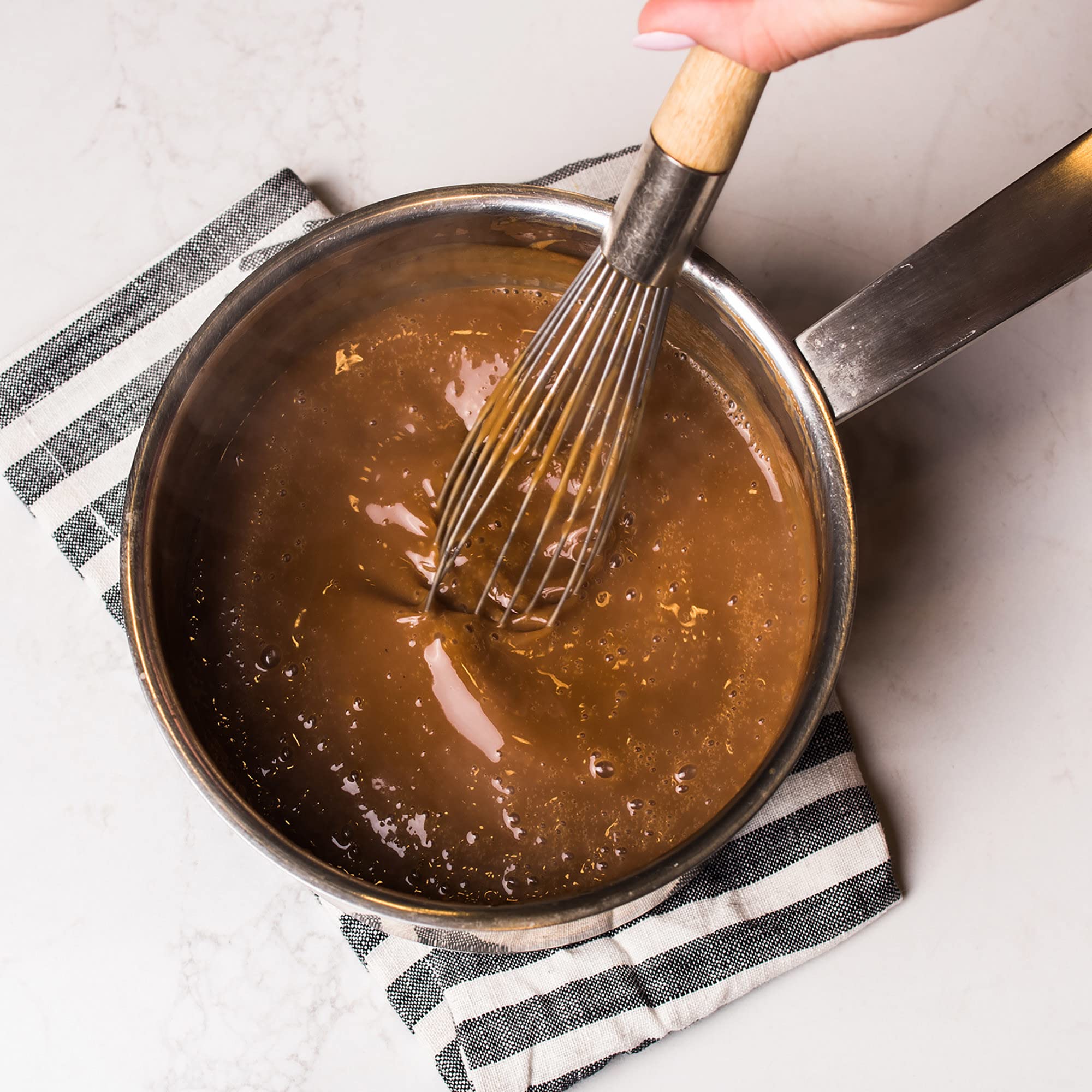 McCormick gravy poured over mashed potatoes enhancing comfort-food appeal