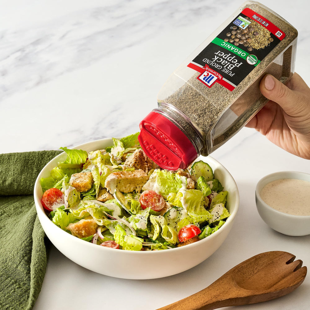 McCormick seasoning steak in skillet with ground pepper for richer savory taste