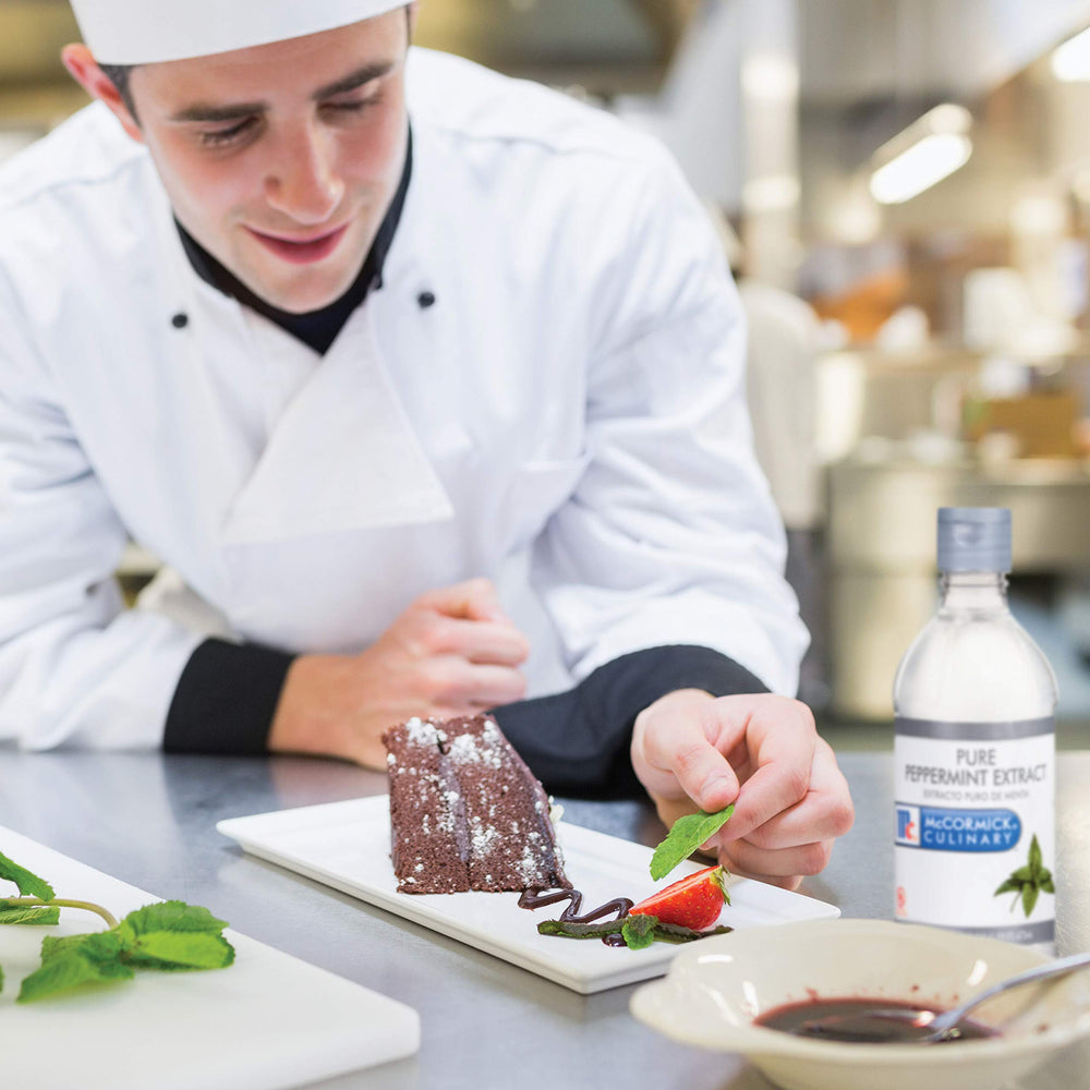 McCormick peppermint extract being mixed into frosting to create mint-flavored icing