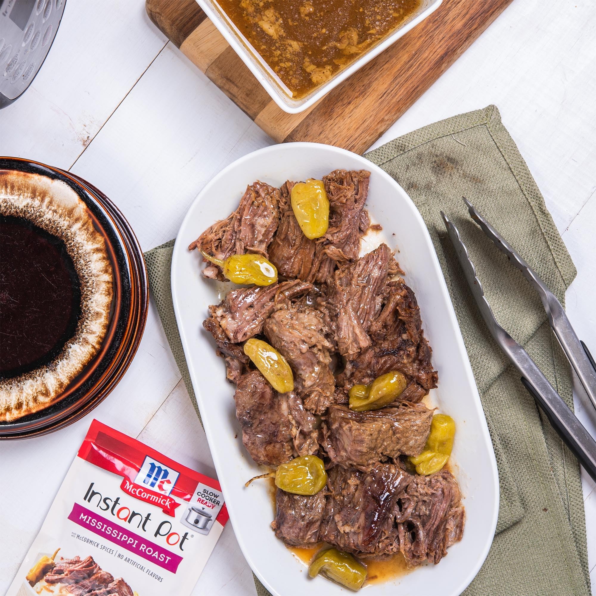 McCormick seasoning packet beside chuck roast for scale and simple portion guidance