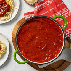 McCormick sauce ladled over pasta showing rich, thick coverage