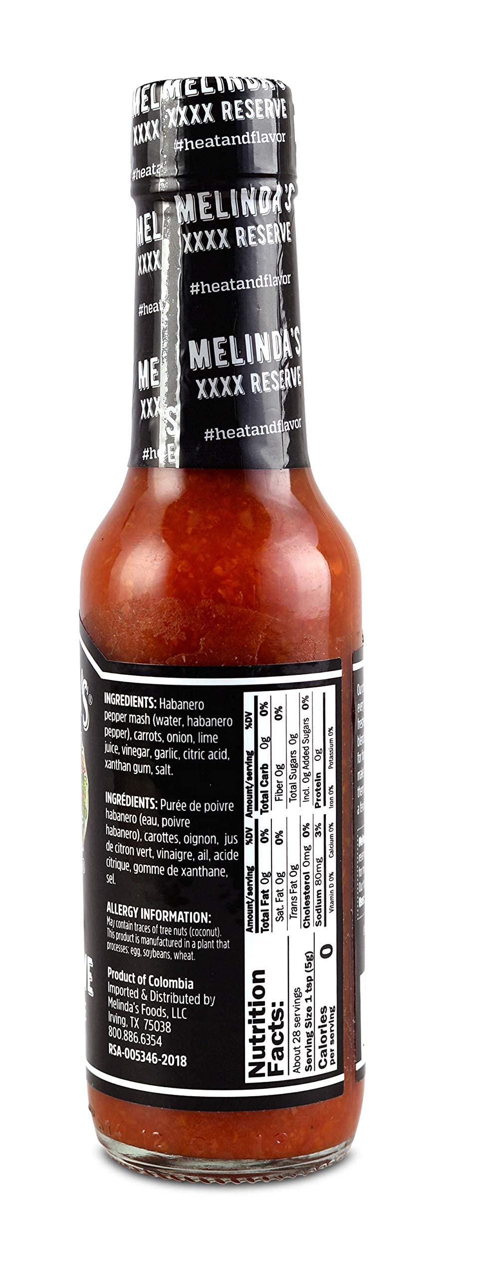 Melinda's sauce pouring over tacos adding balanced heat and flavor