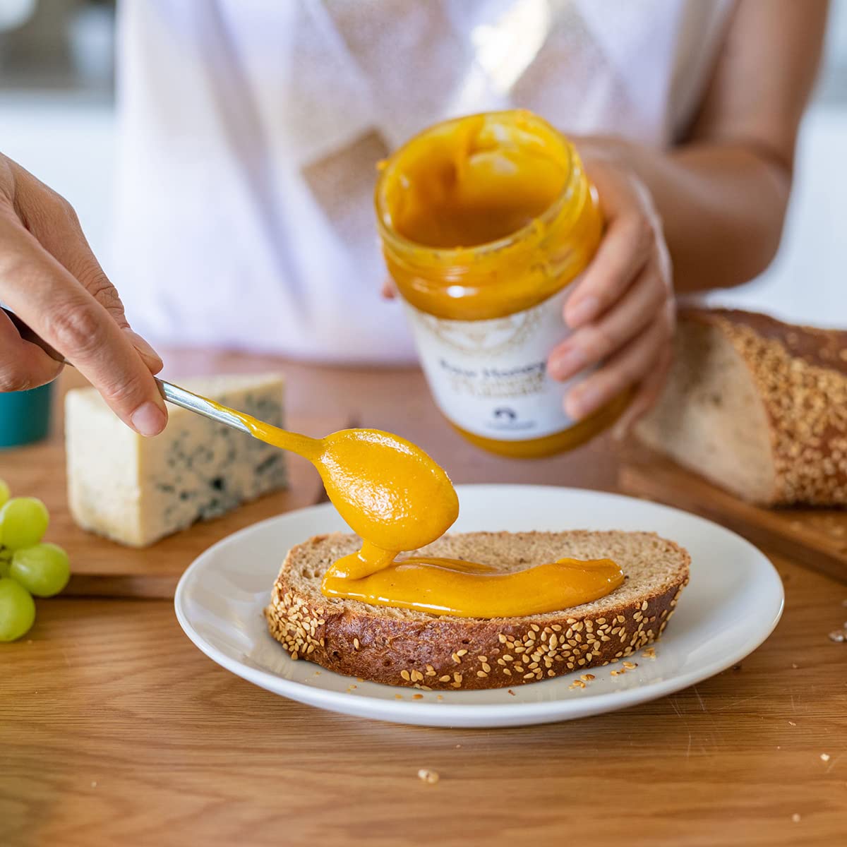 Mellona jar beside spoon showing 700g scale for portion and size clarity