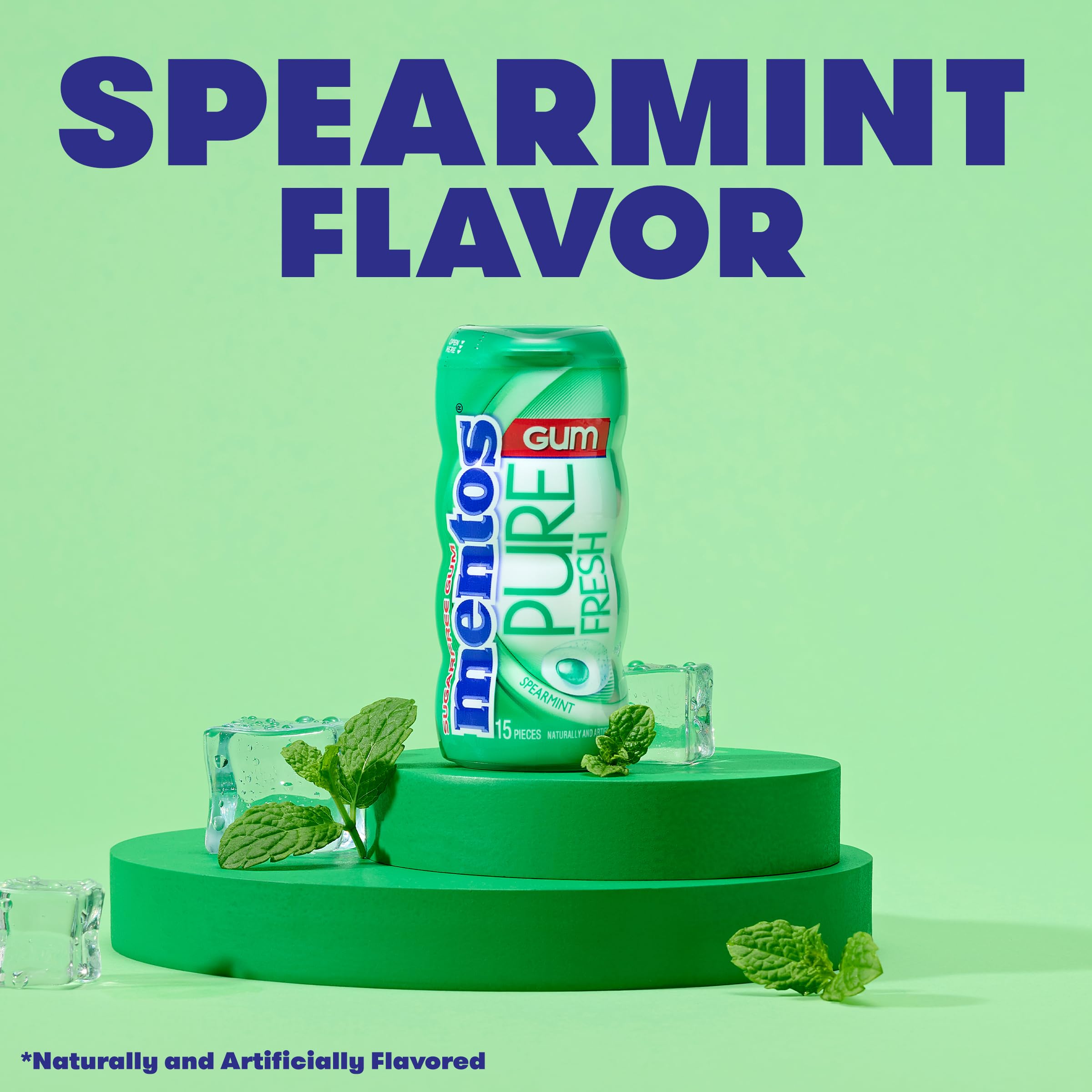 Hand holding Mentos bottle demonstrating portable spearmint gum convenience
