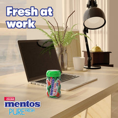 Mentos bottle open with watermelon gum pieces spilling out for easy grab-and-go
