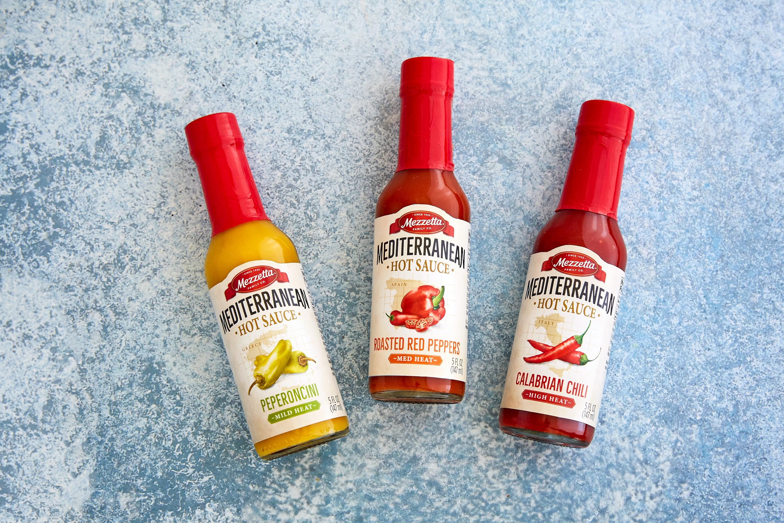 Mezzetta bottle next to common items showing 5 oz scale for portioning