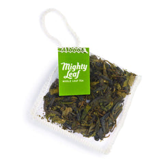 Mighty Leaf flat Dragonwell-style loose leaves detail highlighting toasted chestnut aroma