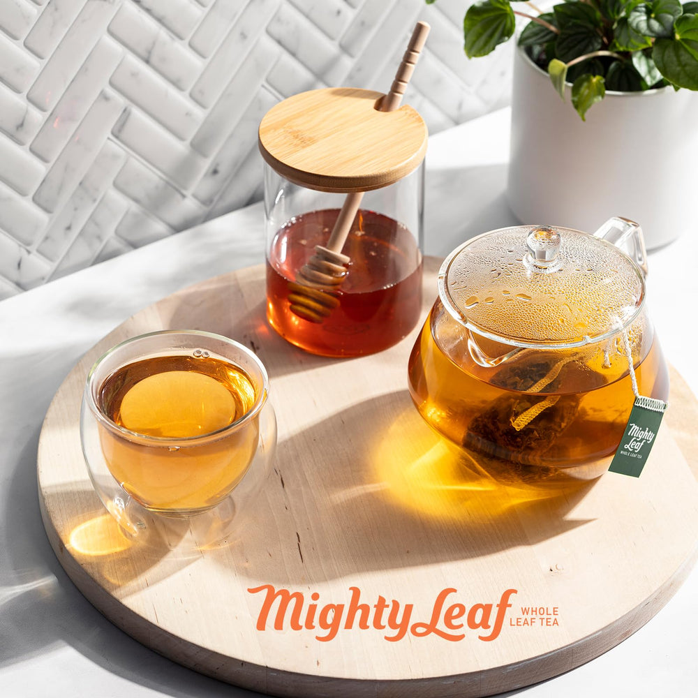 Mighty Leaf box held in hand illustrating 100-count size and pantry-ready convenience