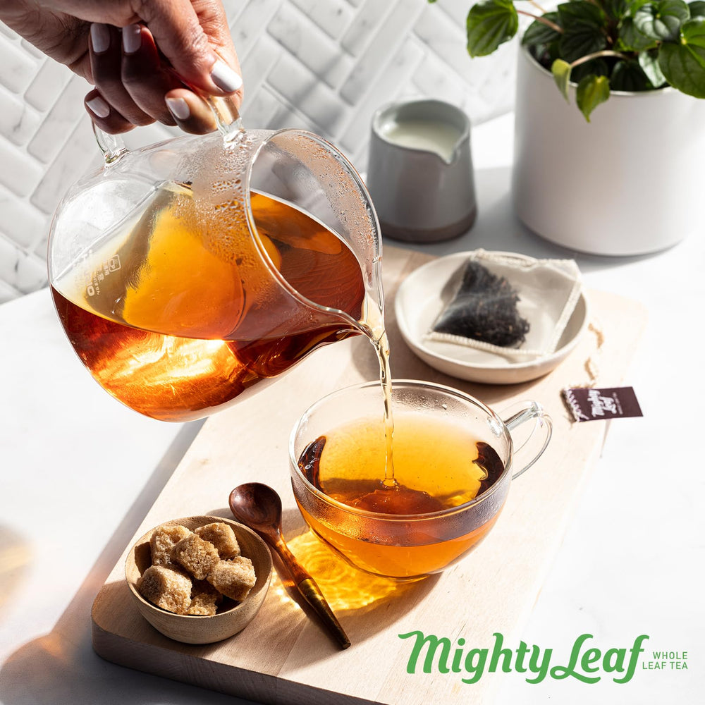 Mighty Leaf package next to mug showing 100-count scale for value
