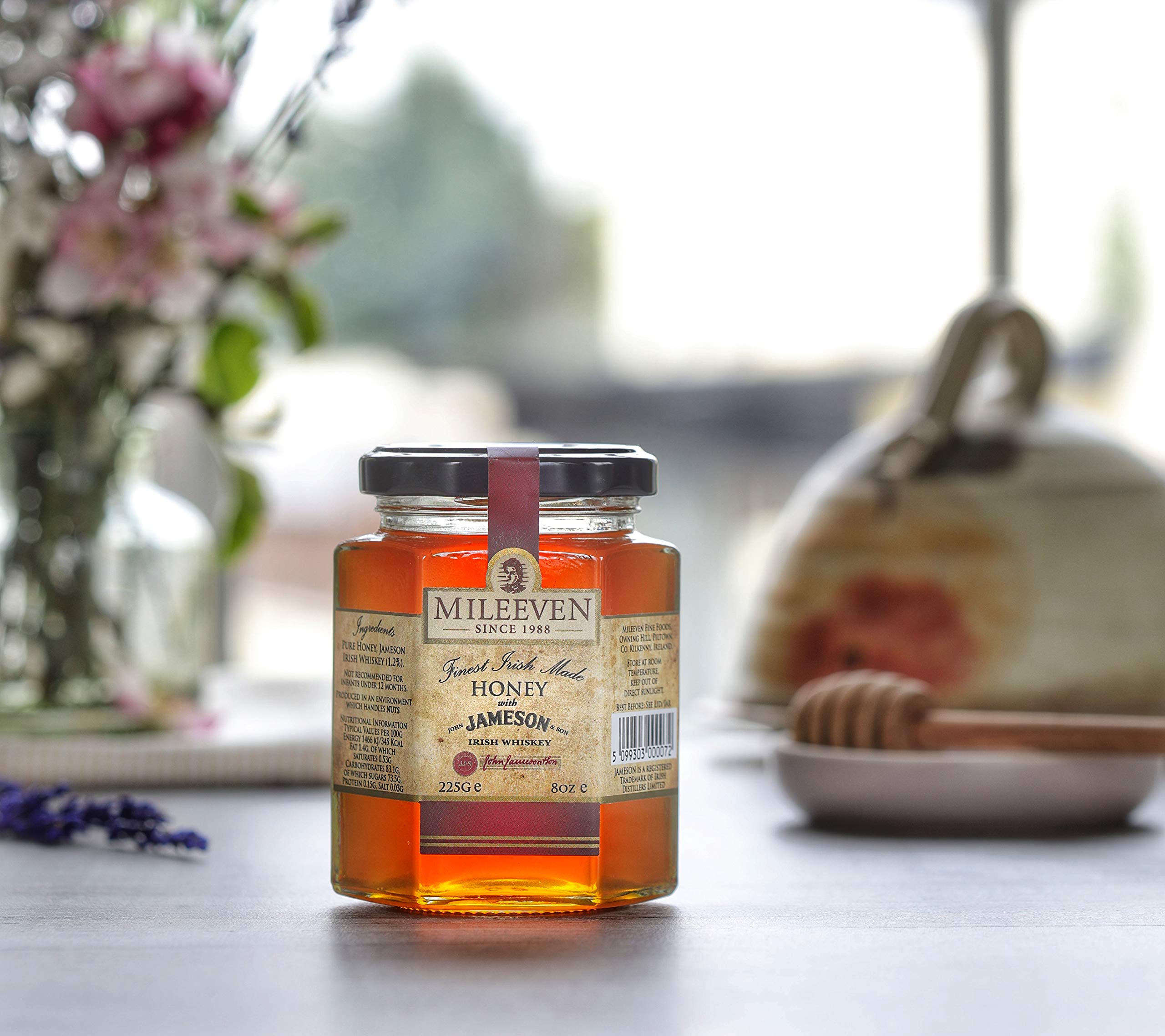 Mileeven spoon drizzling whiskey-infused honey, adds rich flavor to dishes