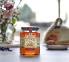 Mileeven spoon drizzling whiskey-infused honey, adds rich flavor to dishes