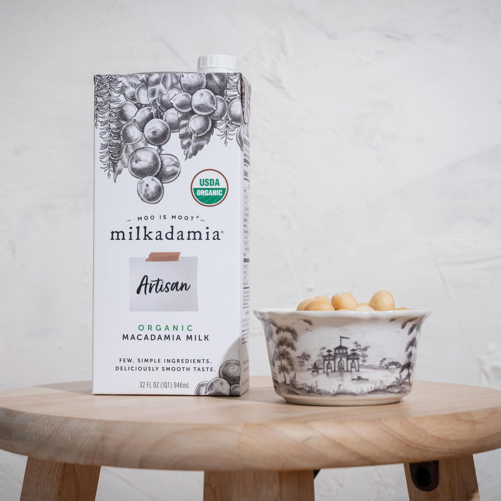 Milkadamia being poured into coffee demonstrating silky blendability