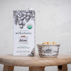 Milkadamia being poured into coffee demonstrating silky blendability