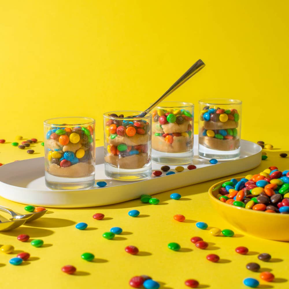 M&M's being portioned into paper bags for party favors and easy sharing