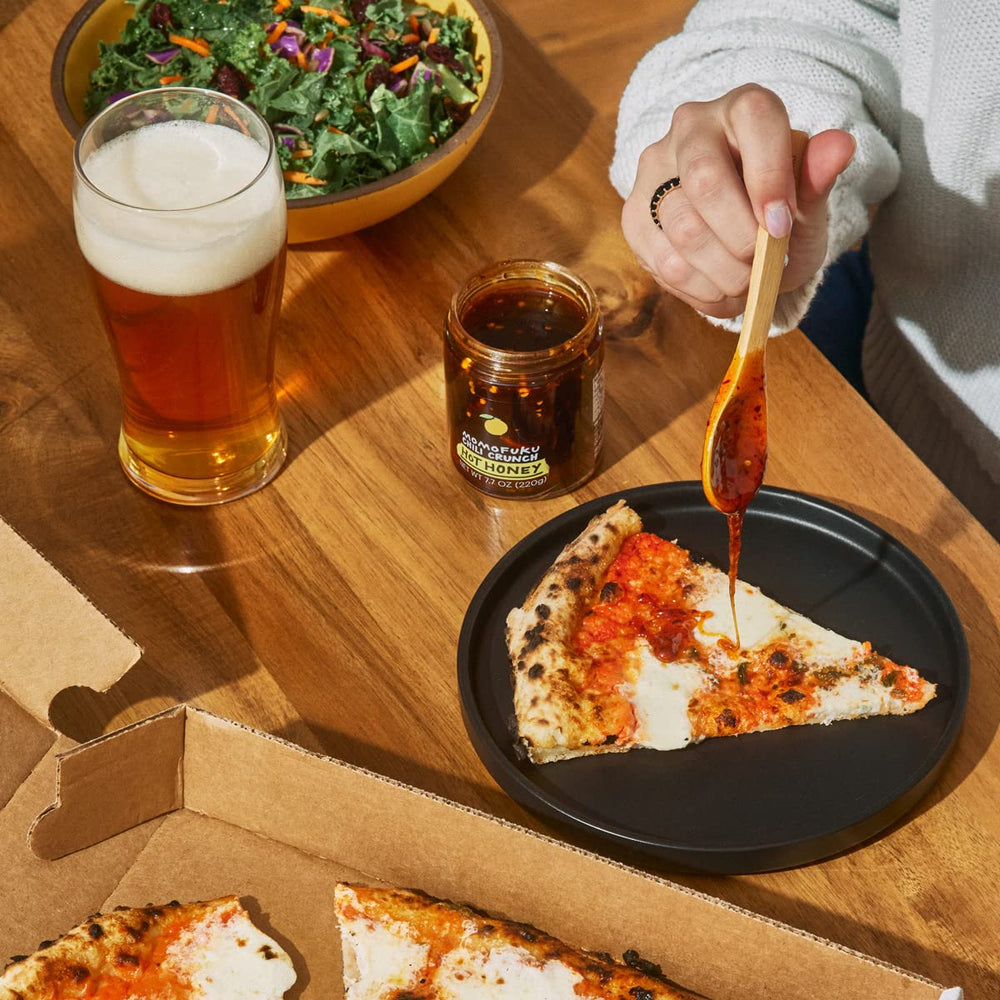 Cheese board styled with Momofuku hot honey chili crunch as a finishing touch