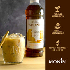 Monin honey syrup being poured into coffee to show easy mixing and flavor