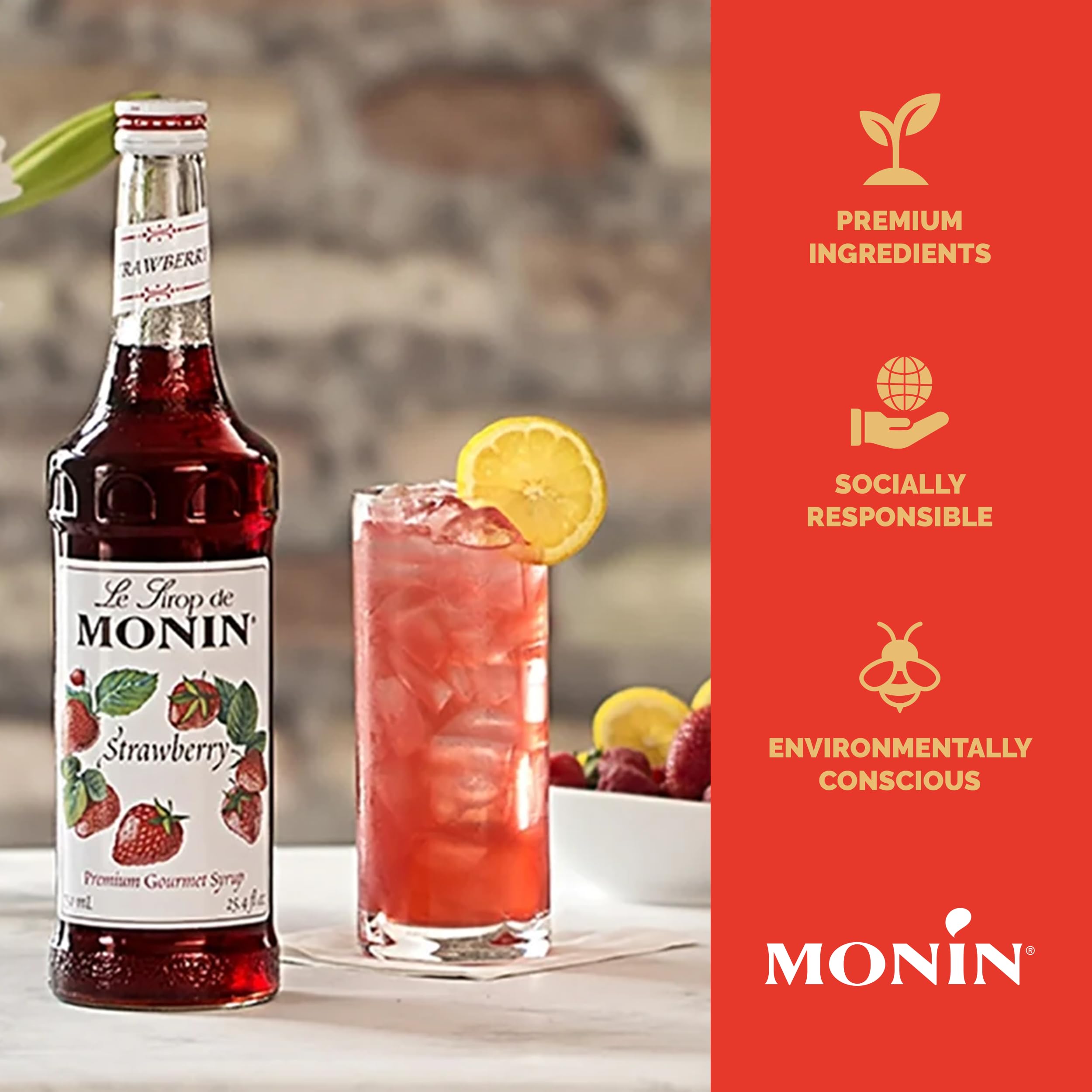 Monin strawberry syrup 750 ml beside a glass for scale and portioning