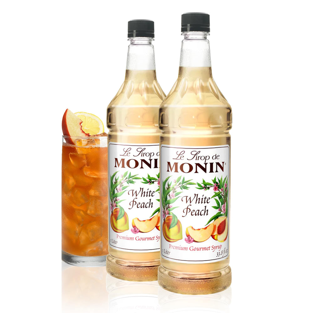 Monin white peach front packaging showing 1L bottle and clean-label benefit