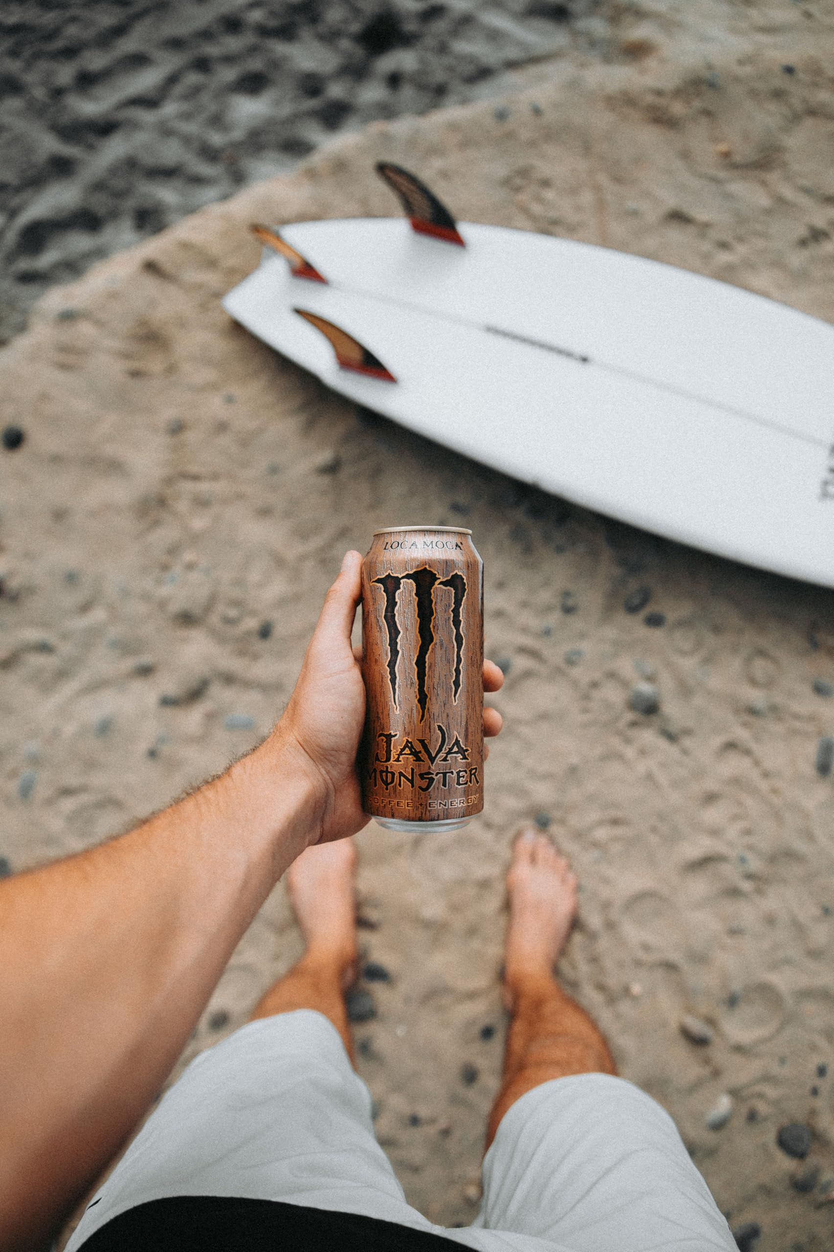 Monster next to phone showing 15 oz size and satisfying serving