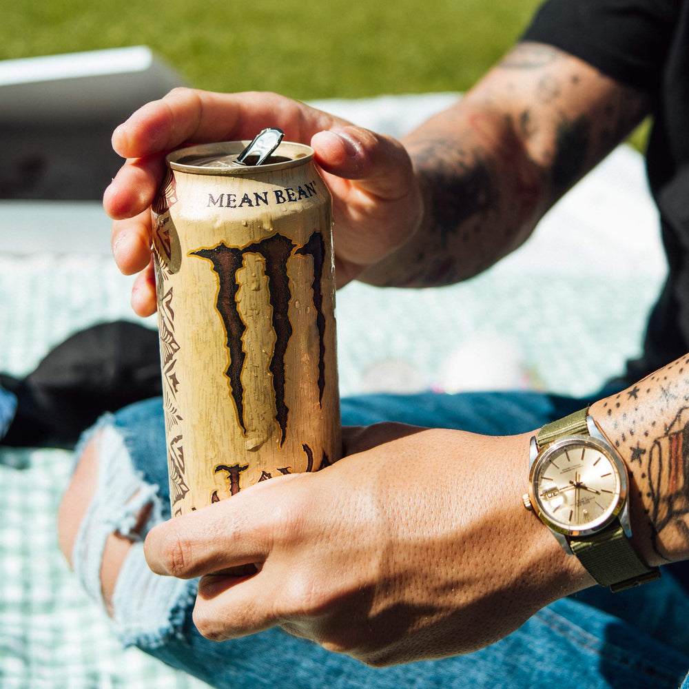 Monster can top open with visible liquid showing ready-to-drink convenience