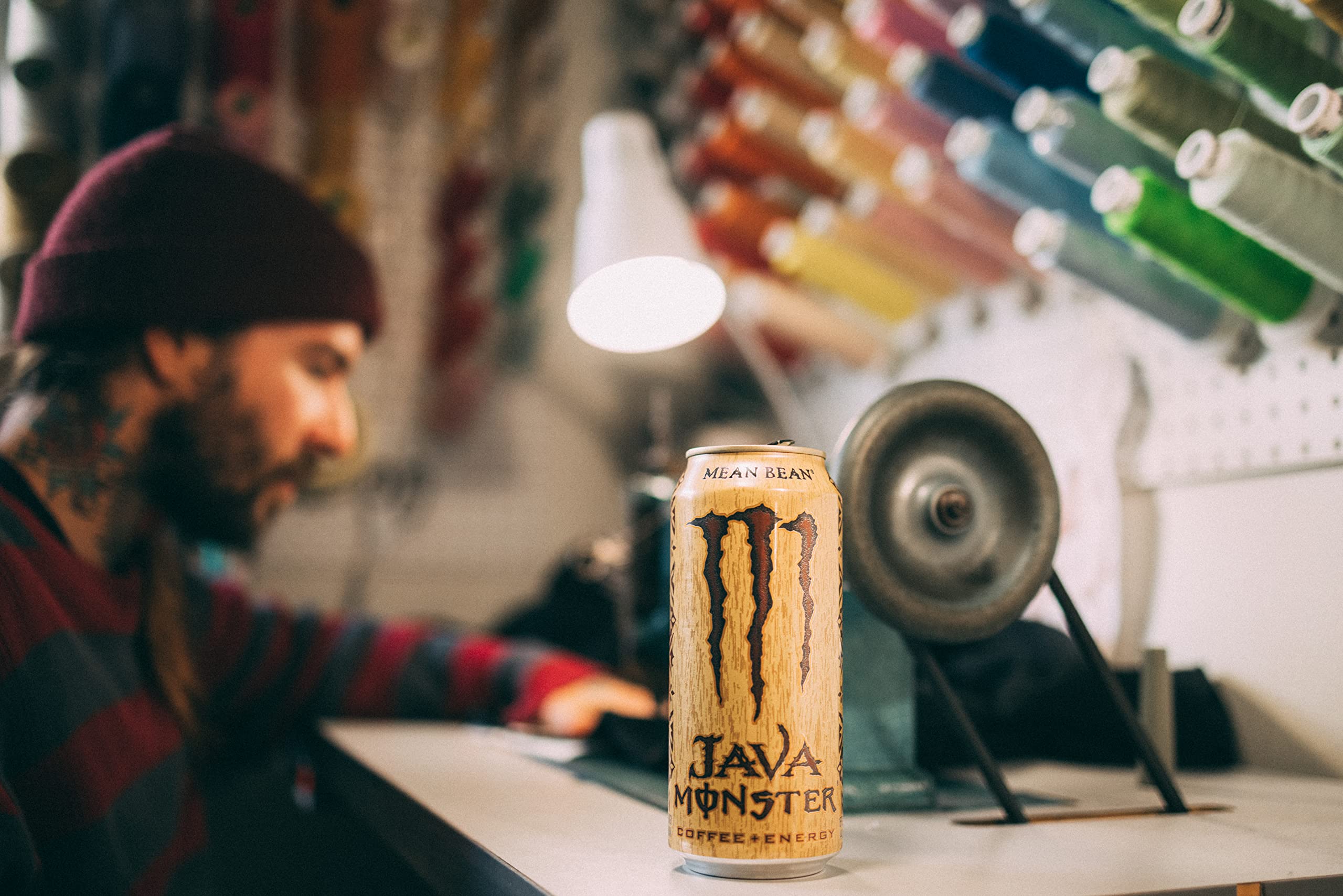 Monster can beside a 12-oz cup showing 15 oz size and generous serving