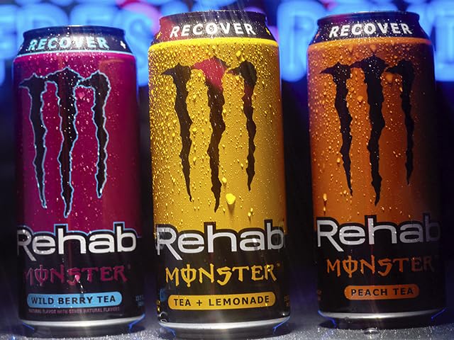Outdoor picnic scene with Monster Rehab cans illustrating hydration and portable refreshment