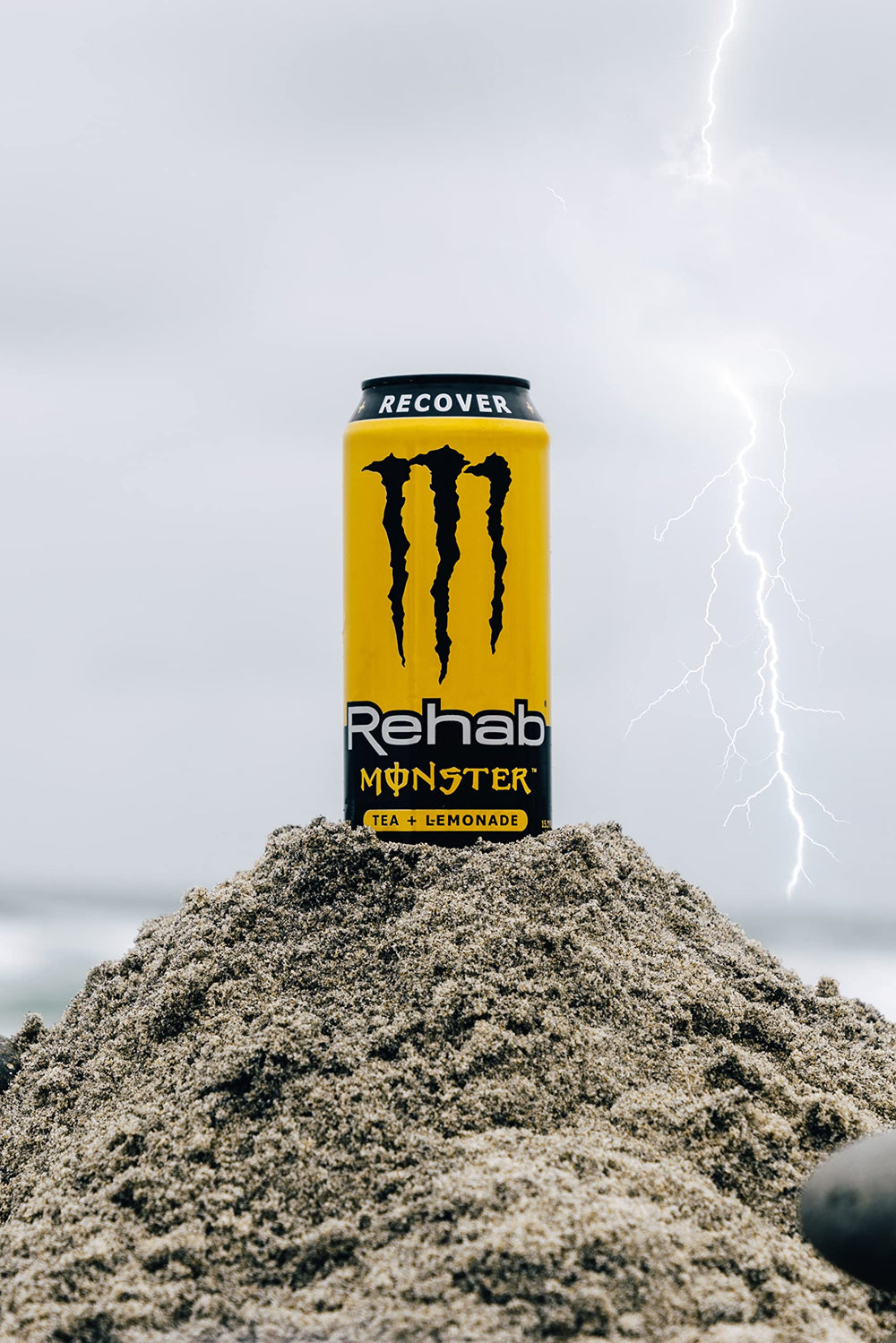 Monster Rehab can on a picnic table demonstrating chilled refreshment outdoors