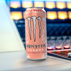 Monster Ultra Peachy Keen on picnic table outdoors illustrating refreshment and shareability