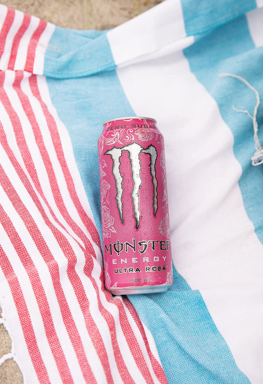 Monster Ultra Rosa can on a picnic table outdoors suggesting refreshing energy